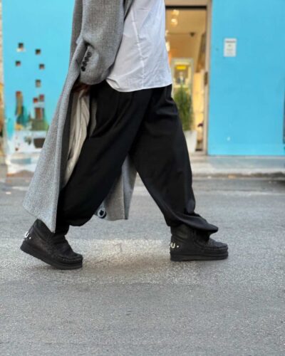 Dettaglio degli stivaletti Mou abbinati a pantaloni ampi per un look autunnale casual e confortevole